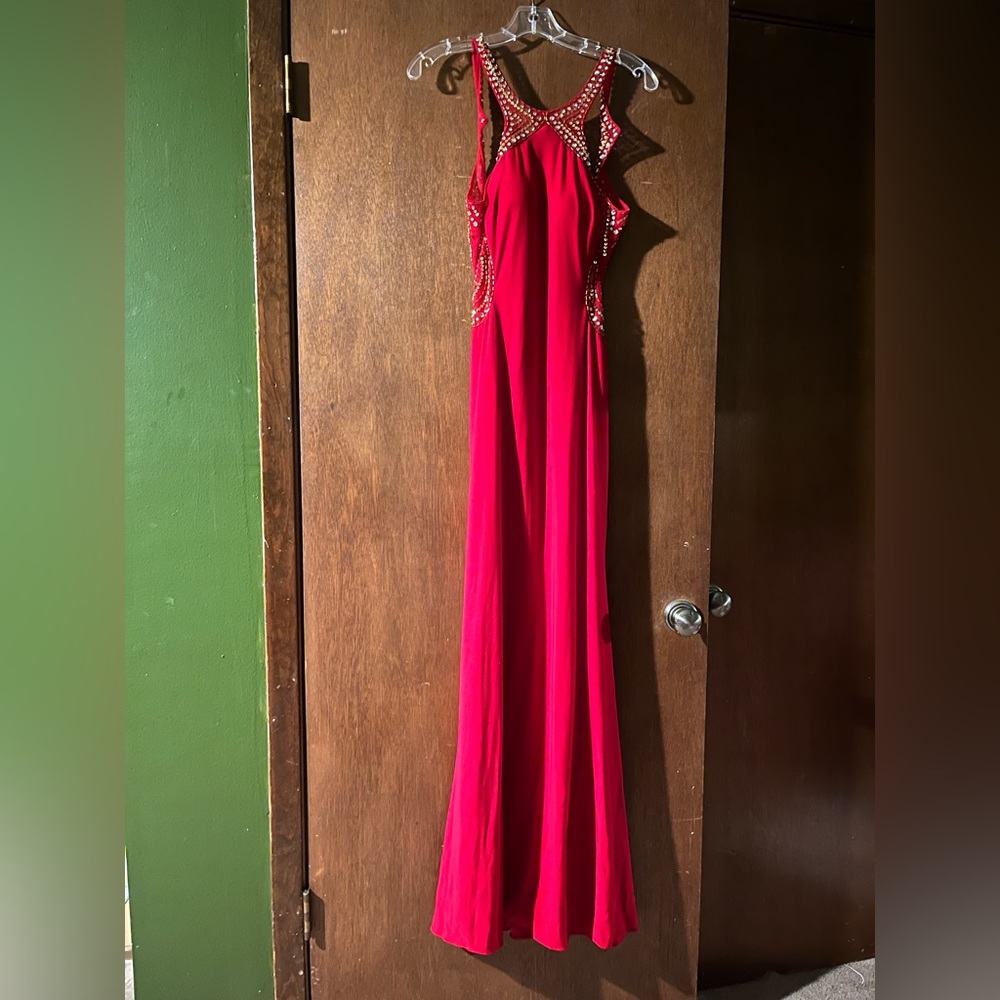 Blonde Nite full length prom dress with sequences and an open back.